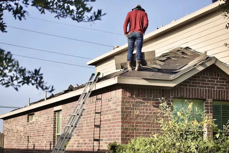 Professional roofer working on a residential roof in Kirbys Mills